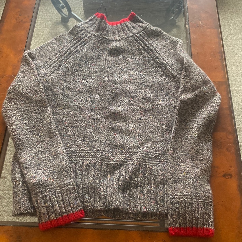 Grey sweater with specs and red piping